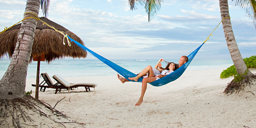 Vacationers Sleeping On a Hammock