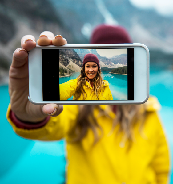 Woman taking selfie in front of mountain