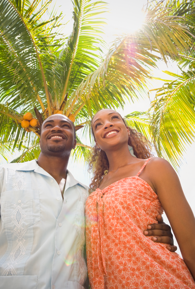 Smiling couple under palm tree